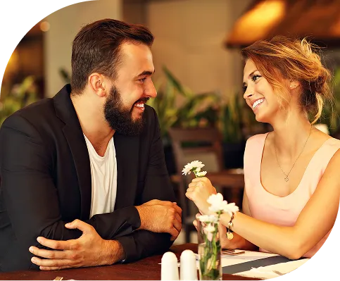 Couple at a table in a restaurant smiling at each other